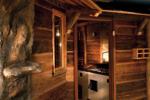 a kitchen in a log cabin with a stove at Parkhotel in Bad Schallerbach