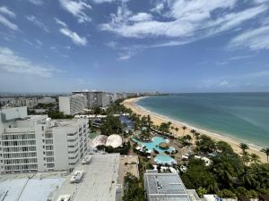 widok na plażę z budynkami i ocean w obiekcie Tropical Studio at the Beach in Isla Verde w mieście San Juan