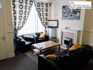 a living room with two couches and a coffee table at 4 Bedroom House at Fern Lodge Preston Serviced Accommodation - Free WiFi & Parking in Preston