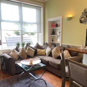 a living room with a couch and a table at Beechwood Ensuite Guest House in Ayr