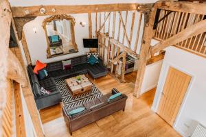 an overhead view of a living room with a couch at Creeksea Place Barns in Burnham-on-Crouch