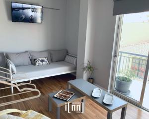 a living room with a couch and a table at inn Kalamata Urban Suites DT in Kalamata