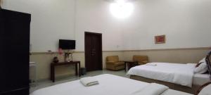 Voodi või voodid majutusasutuse Ndalem Katong Guest House Ponorogo toas