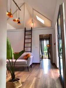 a living room with a staircase and a couch at Casitas de Madera O Loureiro in Noya