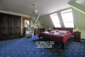 a bedroom with a bed and a chair in it at Willa Ważka in Zielona Góra