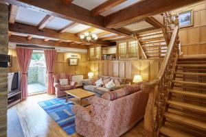 a living room with a couch and a staircase at Host & Stay - The Cottage Barn in Skipton