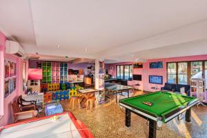 a billiard room with a pool table and a bill at Club Mahindra Acacia Palms in Colva