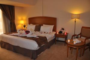 Säng eller sängar i ett rum på Reef Al Malaz International Hotel by Al Azmy