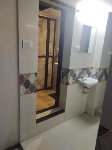 a bathroom with a sink and a mirror at Almas Dormitory Andheri West in Mumbai