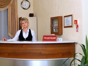a woman sitting at a reception desk in a waiting room at ВІКОНТ in Chyshky