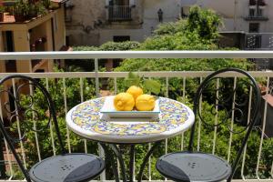 a plate of donuts on a table on a balcony at SWEET SORRENTO HOLIDAYS in Sorrento