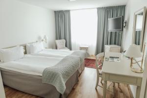 Postel nebo postele na pokoji v ubytování Blommenhof Hotel