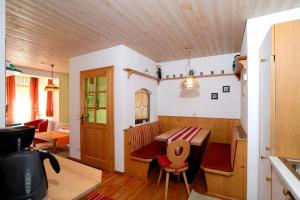 a room with a wooden table and a dining room at Appartementhaus Angerer - Feriendomizile Pichler in Heiligenblut