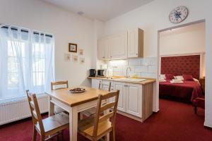 a kitchen and dining room with a table and a room at Penzion U Babky bylinkářky in Kutná Hora