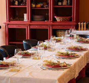 a long table with plates of food and wine glasses at asfodelo ristorante di campagna in Altamura