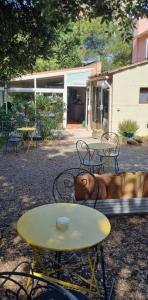 a table and chairs in front of a building at Le Relais Des Lavandins in Le Muy