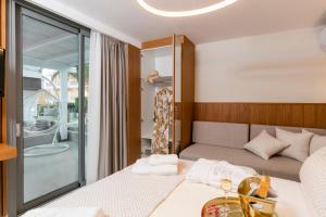 a bedroom with a bed and a table with towels at Pachis Escape Suites in Pachis +245 photos
