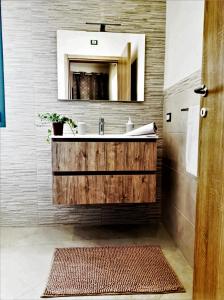 a bathroom with a sink and a mirror at La Palma del Nonno in Mazara del Vallo