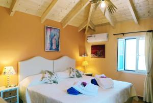 2 camas en una habitación con paredes amarillas en Efi's Cottage by the sea, en Fiskardho