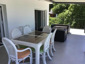 a white table and chairs on a balcony at Kati in Klenovica