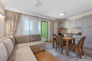 un soggiorno con divano e tavolo di Apartmani Rubinić a Turanj (Torrette)