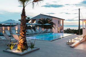 a villa with a swimming pool and a resort at Pachis Escape Suites in Pachis