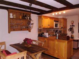 a kitchen with wooden cabinets and a wooden table at Petit Ours in Villars-sur-Ollon