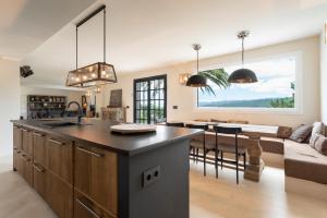 a kitchen and living room with a large window at Casa Boa in Porto do Son