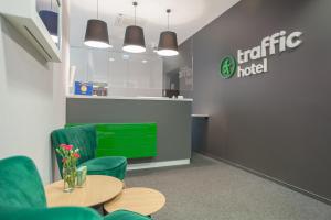 a cafe with green chairs and a table and a counter at Hotel Traffic Wrocław Stare Miasto in Wrocław