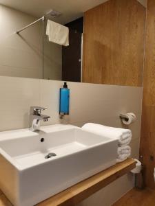 a bathroom with a white sink and a mirror at Apartament w Mielenku nr 19 - 365PAM in Mielenko
