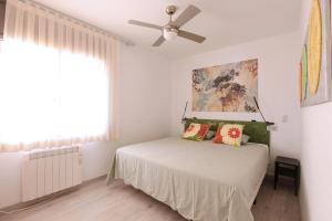 a bedroom with a bed and a ceiling fan at El Mirador de Tossa de Mar in Tossa de Mar