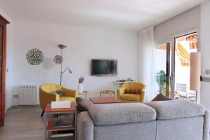 a living room with a couch and two chairs at El Mirador de Tossa de Mar in Tossa de Mar