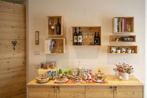 a room with a table with bottles of wine at Casa Galèt in Tirano