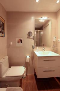 a bathroom with a white toilet and a sink at El Mirador de Tossa de Mar in Tossa de Mar