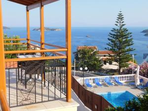 a view of the ocean from the balcony of a resort at elenis village in Achladies