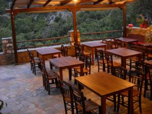 a group of tables and chairs on a patio at Villa Vadola in Arkochórion