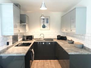 a kitchen with a sink and a counter top at Coedrath Park 14 - Short Walk to Beach, Ground Floor, Parking in Saundersfoot