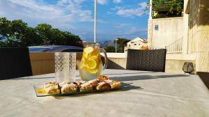 a plate of food on a table with a drink at Garden apartment with a View in Postira