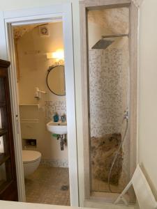 a bathroom with a shower and a toilet and a sink at Amoredimare Casa Vacanze in Polignano a Mare