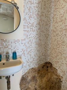 a bathroom with a sink and a mirror at Amoredimare Casa Vacanze in Polignano a Mare