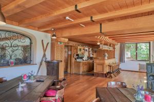 a large kitchen with wooden ceilings and wooden tables at Pension Sonnwend in Fieberbrunn