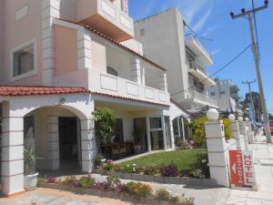 a building in the middle of a street at Parthenis Riviera Hotel in Athens