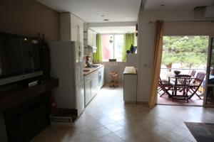 a kitchen with a view of a kitchen with a table at Appart Bin Elouidane in Bine el Ouidane