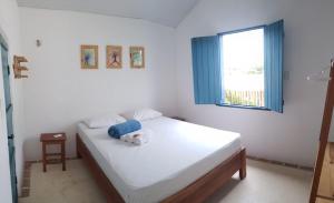 a bedroom with a bed with a stuffed animal on it at CASA PIPA BG in Barra Grande