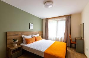 a bedroom with a bed and a window at Hotel Albatros Old Town in Sozopol