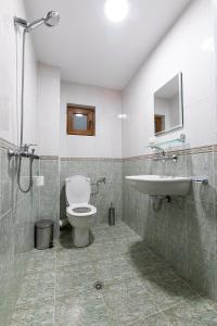 a bathroom with a toilet and a sink at Hotel Albatros Old Town in Sozopol +39 photos