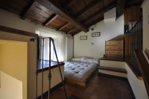 a living room with a bed and a staircase at Relax Colleverde in Colle Verde