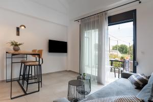 a living room with a couch and a table at Cove Suites in Iraklitsa