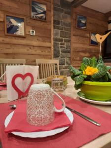 un tavolo con una tazza di caffè su un tovagliolo rosso di B&B Lorelei a Gressoney-Saint-Jean