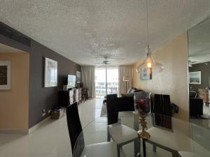 a dining room and living room with a glass table at 2BR Condo at Isla Verde Beach in San Juan